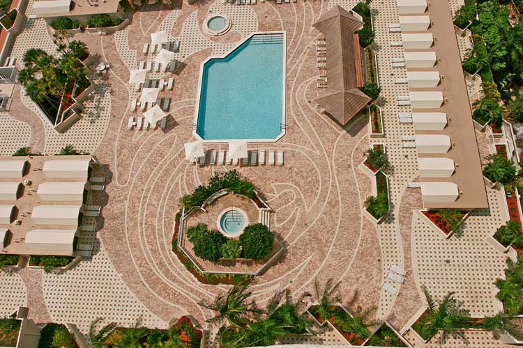 Terreaces at Turnberry Condo pool with the associations logo laid out in the concrete pavers of the deck - Aventura, Florida