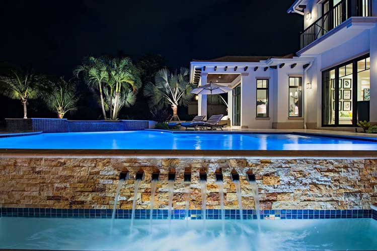 View across pool from sunken seating are in an Estate lot in Estuary - Naples, Florida