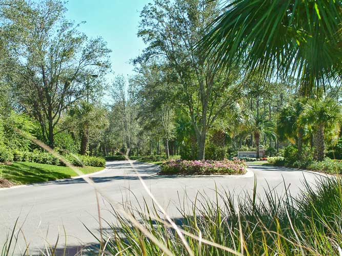 A divided roadway with landscape median in Mediterra - Naples, Florida